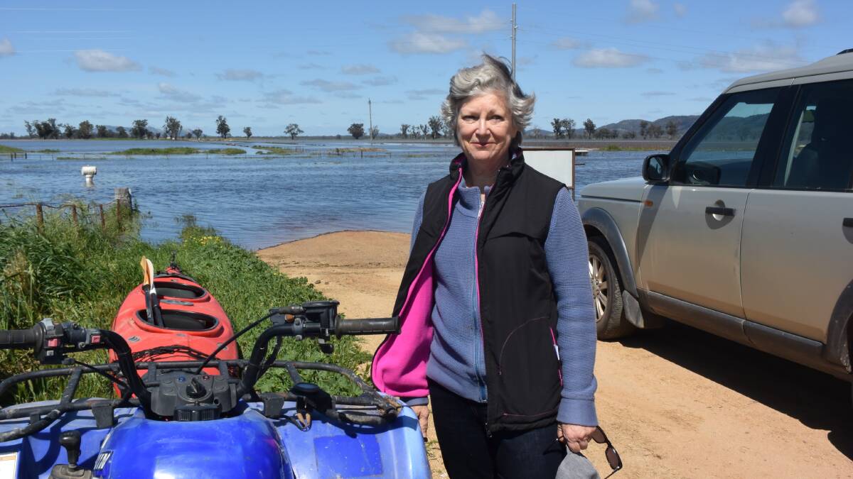 Forbes district farmer Sarah Black at the front gate of Riversleigh on the flooded Forbes to Condobolin Road. 