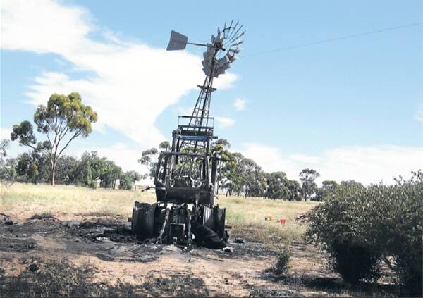 FARM TRAGEDY: The burned tractor and windmill on the Nhill-Rainbow Road property near Rainbow yesterday. The windmill is hooked on a single power line. Pictures: AMANDA WILSON