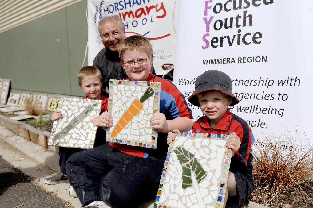 Horsham Primary School students show off their completed mosaic tiles which will go on display in the school's veggie garden. Picture: SAMANTHA CAMARRI