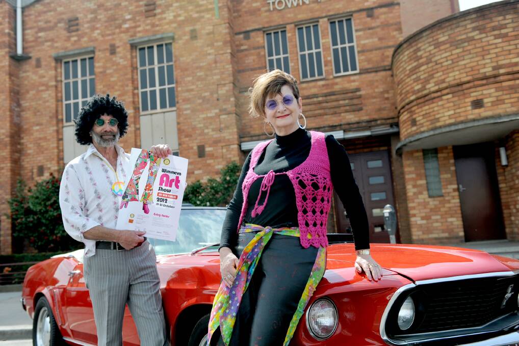 Horsham East Rotary Club members Don Mitchell and Robyn Lardner, pictured with a 1969 Cobra Jet Mustang convertible, dressed in their best 1970s gear on Wednesday to promote the Art with Flair(s) themed Wimmera Art Show at Horsham Town Hall from October 19-21.