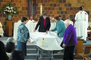 CEREMONY: Brigidine nuns Sr Rosie Joyce, Sr Geraldine Sheedy, Sr Deidre Malone and Sr Monica Touhey place a pall on Sr Veronica's coffin.