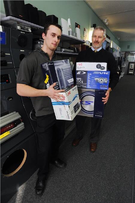 LUCKY: Chisholm Hi Fi staff member Marc Richards and owner Jeff Allan with the equipment a couple tried to buy with cheques linked to an empty bank account. Picture: KATE HEALY
