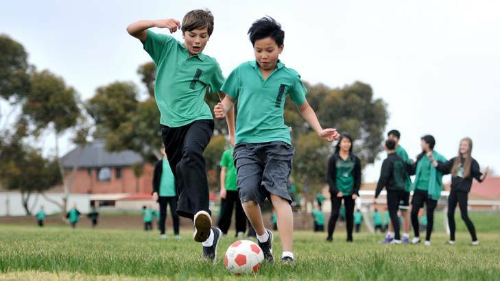 William Micallef and Chris Chiam (right) play soccer at Mackellar Primary in Delahey – a school that meets the targets for hours of sport per week.