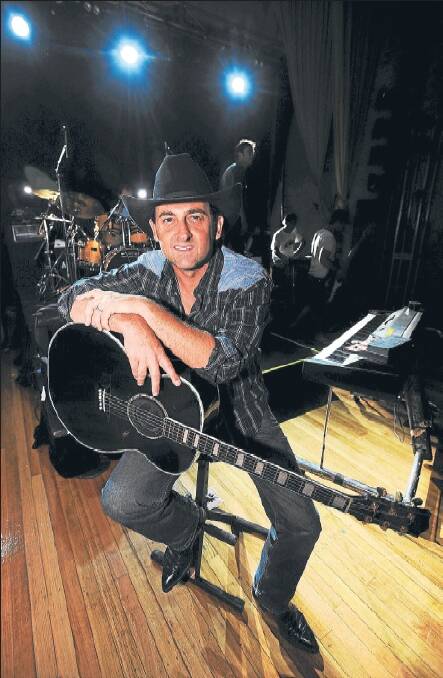 READY TO PLAY: Lee Kernaghan takes the Horsham Town Hall stage for a soundcheck on Friday afternoon. He said it was a privilige to be back in the Wimmera. Picture: KATE HEALY
