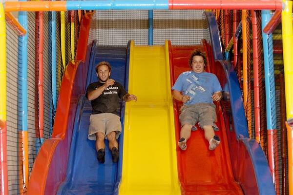 CHILDREN'S PLAY: Horsham's Joe Parish and Brad Treloar race on the slides at Kids Capers. The pair worked on the project, including construction of the play equipment. Picture: SAMANTHA CAMARRI