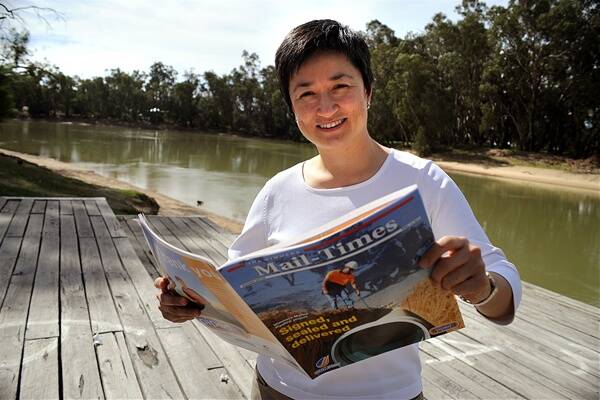 IMPRESSED: Federal Water Minister Senator Penny Wong takes a look at the Mail-Times' special 52-page souvenir on the Wimmera-Mallee Pipeline during a visit to Swan Hill on Wednesday. Picture: PAUL CARRACHER
