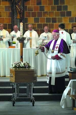 BLESSING: Bishop Peter Connors blesses Sr Veronica Carr's casket.