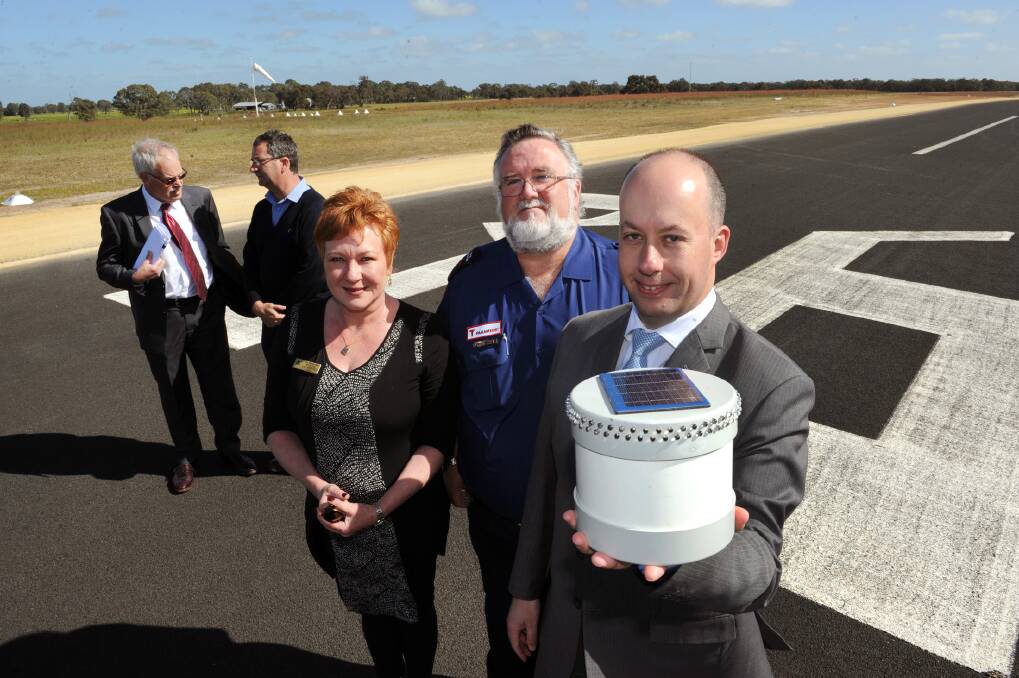 LIT UP: Aviation Minister Gordon Rich-Phillips, front, holds a new runway light. He announced new funding for Edenhope s aerodrome, including for new lighting, on Wednesday. Pictured at the announcement are, from left, West Wimmera Shire chief executive Mark Crouch, works manager Terry Ough, Mayor Eveline van Breugel and Edenhope Ambulance team manager Malcolm Hunting. Picture: PAUL CARRACHER