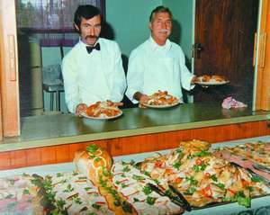 ALFONSO Baviello with son Michael Baviello display plates of delicious food at an event they catered for decaades ago.