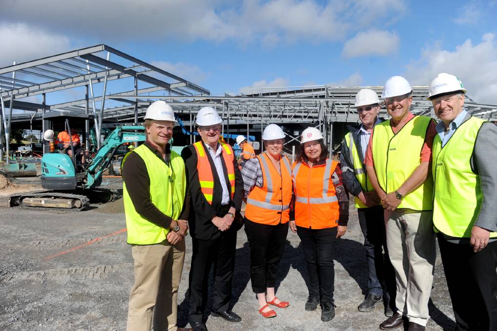 ON SITE: Gateway Property developer Ken Foss, Horsham Rural City Council chief executive Peter Brown, Target Country Horsham store manager Tracey Focroul, Target Australia construction project manager Monique Worthy, project superintendent John Manning, Horsham Mayor David Grimble and council planning and economic director Tony Bawden on site at Horsham s $12-million Target redevelopment in Wilson Street yesterday. The project architect has dubbed it the Western Woolshed . Picture: SAMANTHA CAMARRI