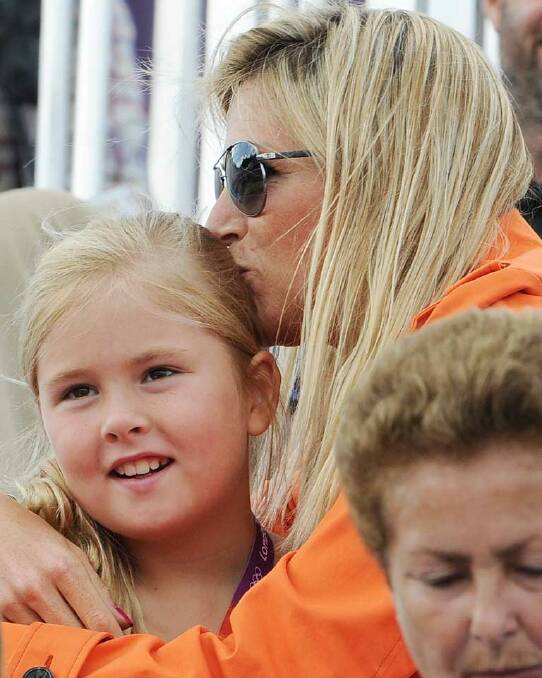 ...And again, Princess Catharina-Amalia of the Netherlands (L) and Princess Maxima of the Netherlands share a moment in the sun at the equestrian events on day 7.