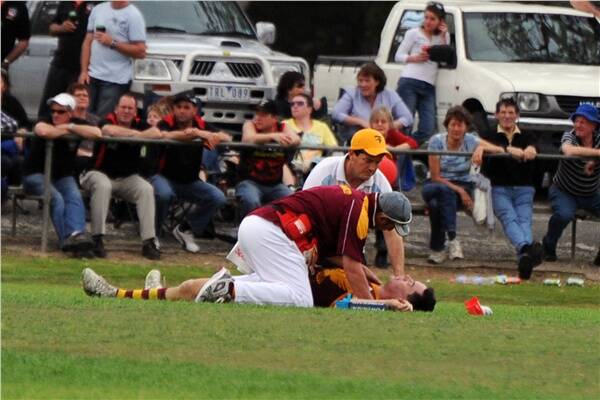 DEFINING MOMENT: Warrack Eagles trainers try to help midfielder Ben Spicer who lay on the ground after a heavy clash.