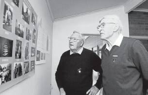IMAGES OF THE PAST: Horsham Angling Club life members Bill Harris and Ron Preuss survey old pictures at the centenary.