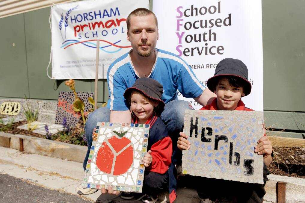 Horsham Primary School students show off their completed mosaic tiles which will go on display in the school's veggie garden. Picture: SAMANTHA CAMARRI