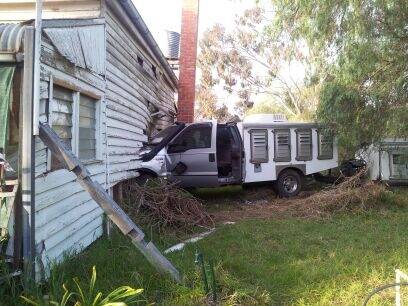A ute sits embedded in the wall of a house at Kiata after the vehicle veered off the Western Gighway on Friday morning. Picture: NHILL POLICE