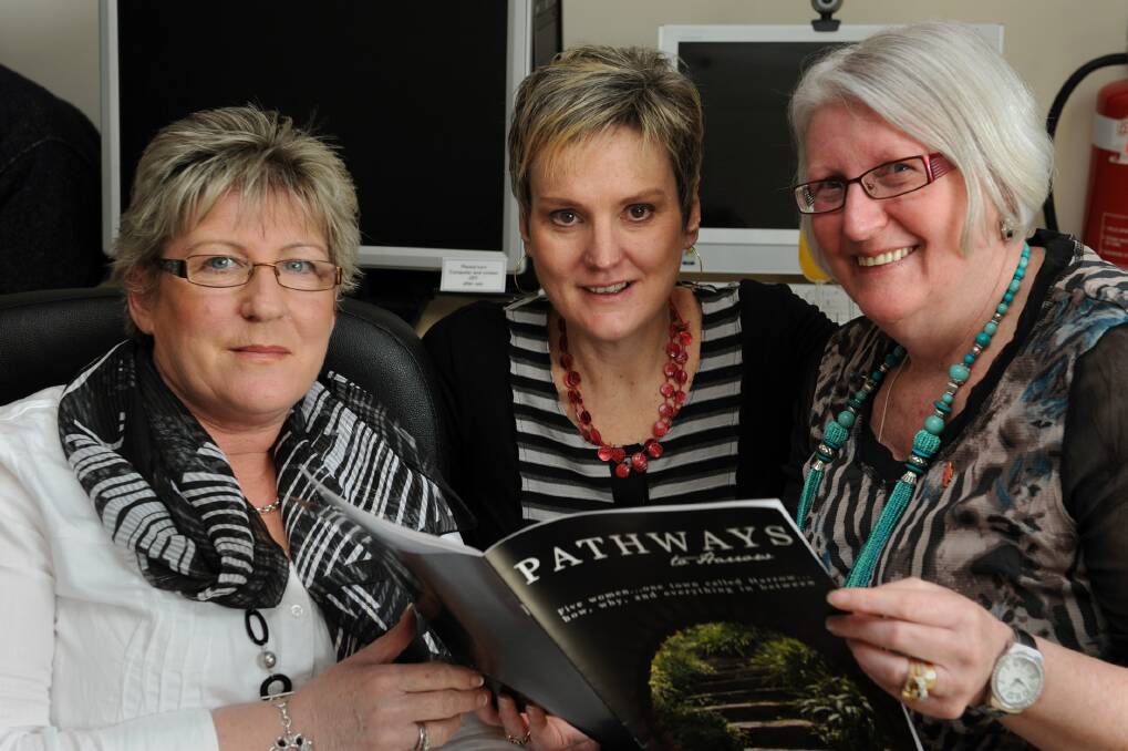 Theresa Pahl, Nic Storey and Pat Walker flick through the pages of the Pathways to Harrow booklet celebrating rural women.