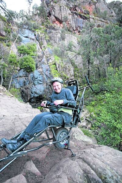 BACK TO NATURE: Retired university lecturer and multiple sclerosis patient Dr David Stratton during an Australia-first trial of the all-terrain wheelchair TrailRider.