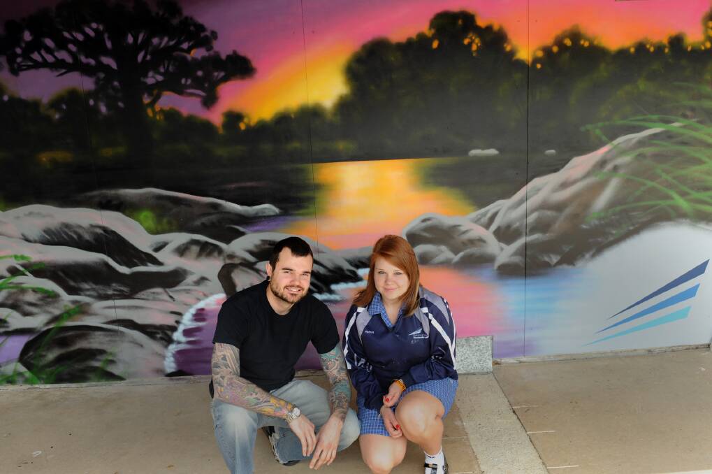 Artist Brett Hayes with Balmoral College VCAL student Melissa Metlika in front of one of the two new murals at the school. Picture: PAUL CARRACHER