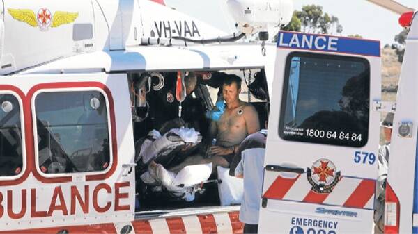 INJURED: Nathan Wheeler sits in the helicopter waiting for transport to Horsham.