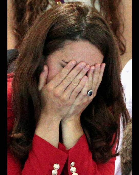 ...And goes on to bury her head in her hands. The Duchess of Cambridge watches the swimming finals.