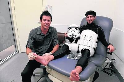 TOUGH SOUL: Jacob French welcomes a free foot check-up by Horsham podiatrist Adam Chalmers on Saturday morning. Mr Chalmers said the Star Wars fanatic's feet were in great shape despite his epic journey. Picture: PAUL CARRACHER