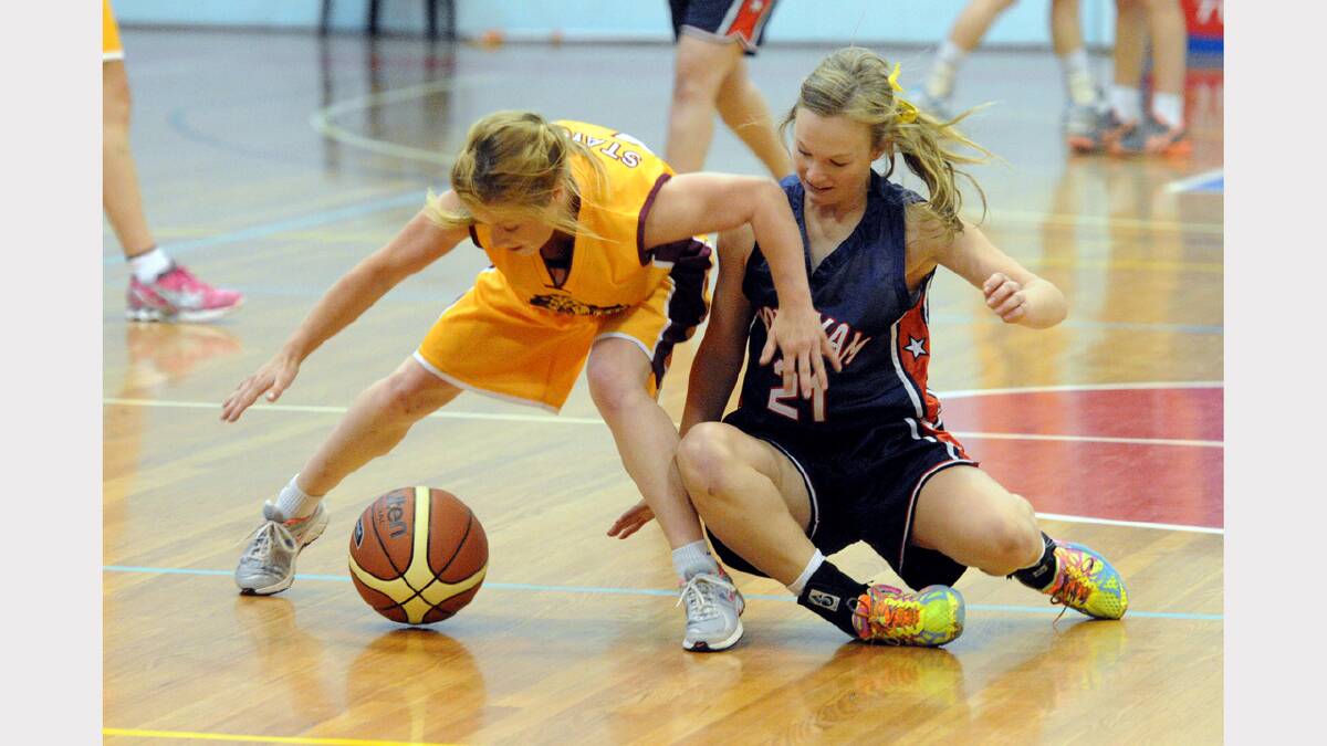 BATTLE: Wildcat Chelsea Hall and Hornet Aily McAuliffe battle for the ball at the weekend