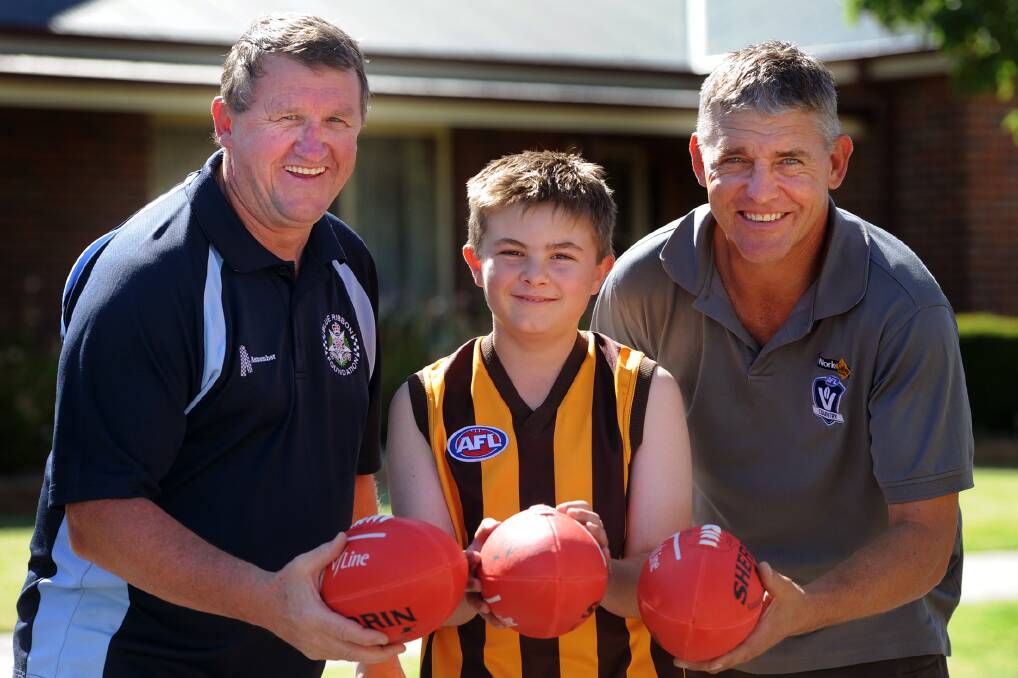 NEW LEAGUE: Blue Ribbon Foundation's Les Power, junior footballer Dylan Thompson, 10, and AFL Victoria Country Wimmera football development manager Bruce Petering are excited about the new AFL Wimmera Mallee Little League. Picture: SAMANTHA CAMARRI