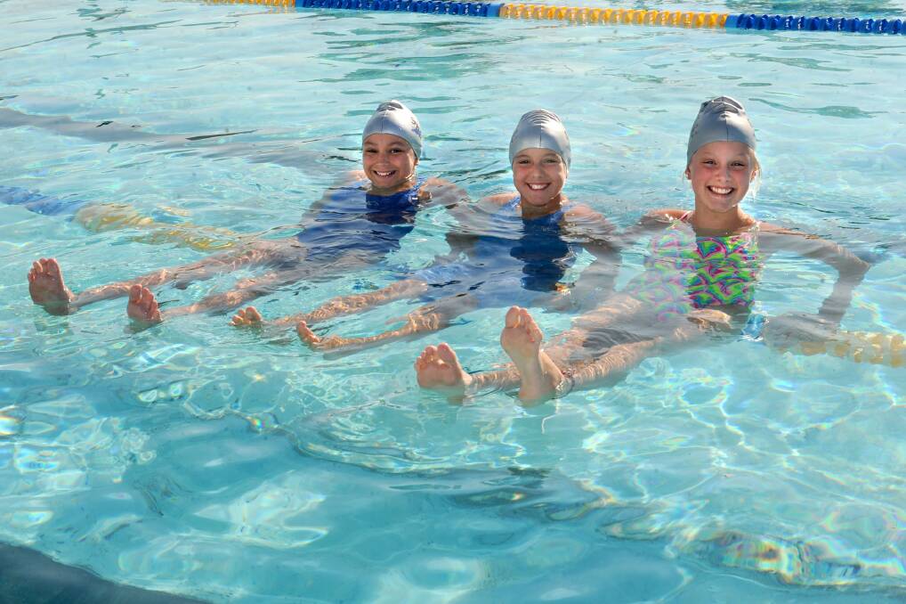 OFF TO WODONGA: Horsham Swimming Club juniors Bella Geue, 11, Miette Hopper, 11, and Layla Atherton, 12, will be at the Victorian Country Swimming Championships in Wodonga, starting Friday. Picture: SAMANTHA CAMARRI