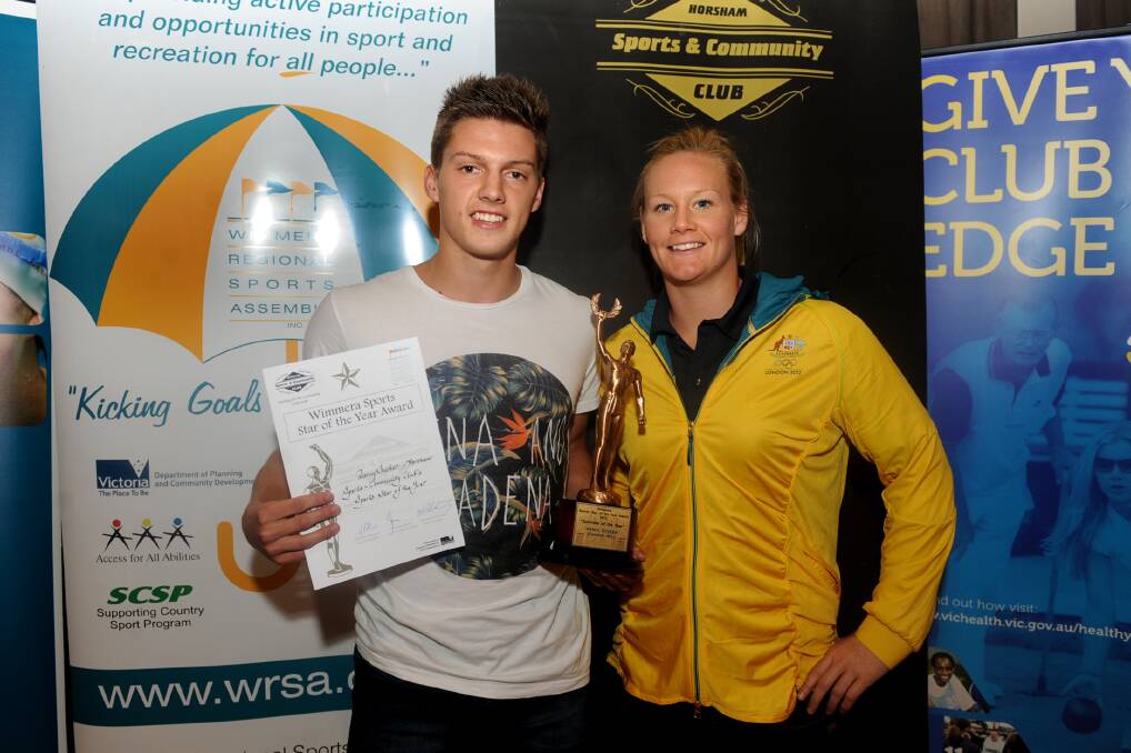 BEST OF THE BEST: Horsham Saints footballer Darcy Tucker was named the Wimmera Sports Star of the Year on Monday night. He is pictured receiving his award from Olympic water polo player and bronze medallist Rowie Webster, who was guest speaker. Picture: SAMANTHA CAMARRI