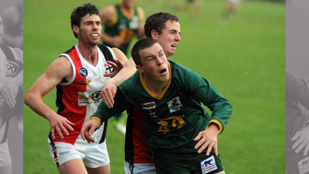 Hamish Exell in front of Nathan Clough and Addison Milner. Wimmera Football League grand final at Davis Park, Nhill. 