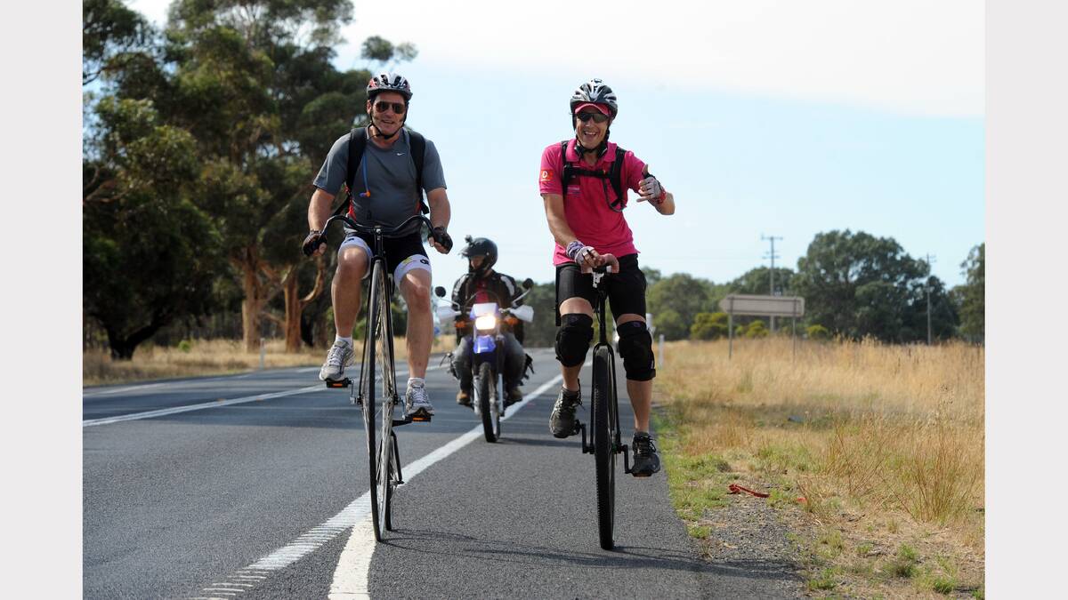 Actor Samuel Johnson riding his unicycle  along the Western Highway with Horsham's Dan Bolwell. 