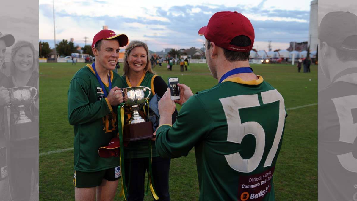 Hamish Exell and girlfriend Anna Lehmann get picture taken by Tom Magee. Wimmera Football League grand final at Davis Park, Nhill. 