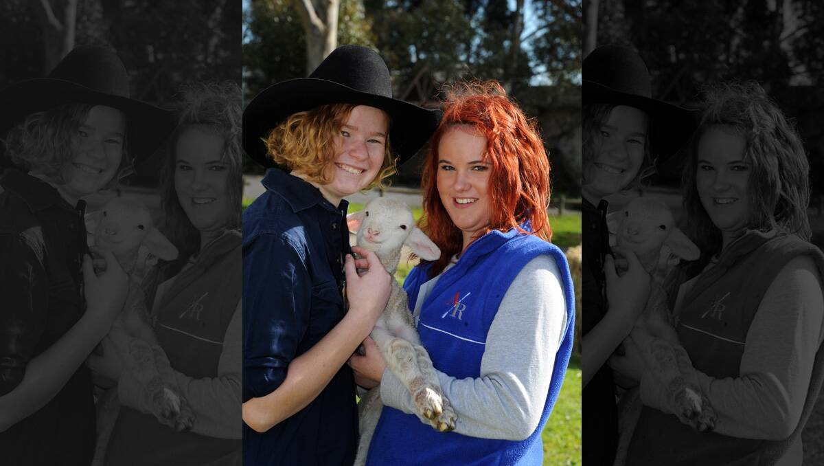 First year student Summer Dehnert shows prospective student Raevan Gratten-Watson a young lamb at Longy open day. 