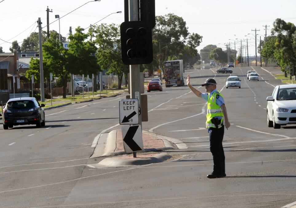 Senior Constable Heath Martin directs traffic in Dimboola Road.