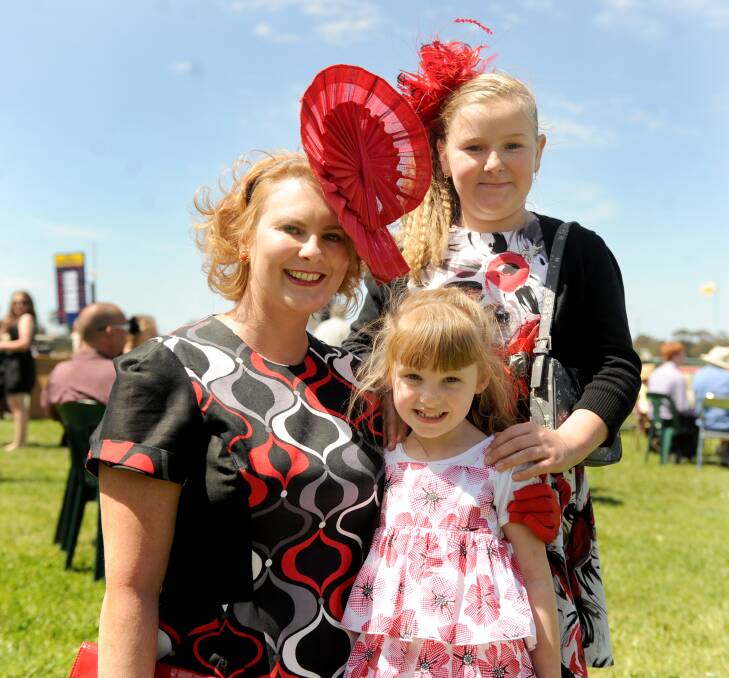 Carly, Holly and Rubi Crouch all dress in red for the 2012 Horsham Cup. Picture: SAMANTHA CAMARRI 