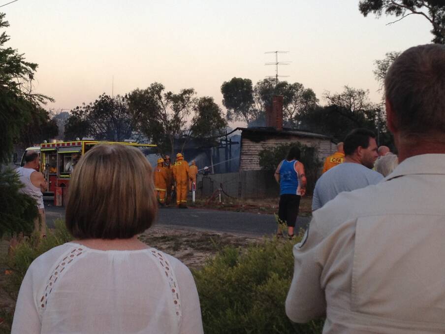 BLAZE: Dimboola residents watch as a property on the corner of Faith Street and Nhill Road burns on Tuesday night. Picture: STACEY KING