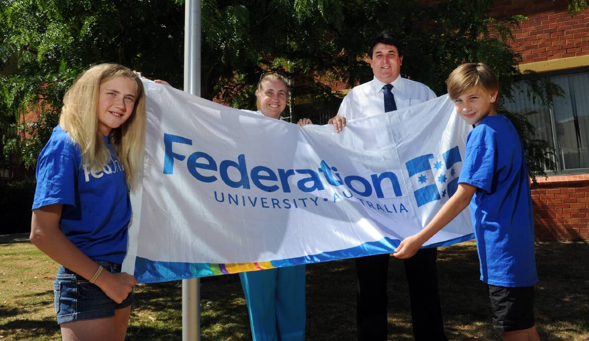 NEW NAME: Federation University early childhood education senior lecturer Alison Lord and western campuses head Geoff Lord with their children Morgan Lord, 12, and Jack Lord, 10, celebrate the University of Ballarat changing to Federation University. Picture: PAUL CARRACHER