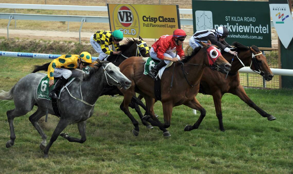 PHOTO FINISH: Hell’s Kitchen, ridden by Steven Vella, centre, wins the inaugural Halls Gap Cup at Stawell Racing Club in 2013 from De Mars, Harry Coffey, and Freshwater Storm, Jason Childs. Pictures: PAUL CARRACHER