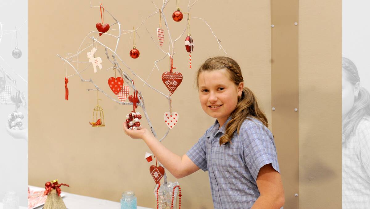 CREATIVE: Holy Trinity Lutheran School grade three pupil Dana Haughton, 9, with the tree she made for the school’s Christmas Festival, which took place between Friday and Sunday. Picture: SAMANTHA CAMARRI