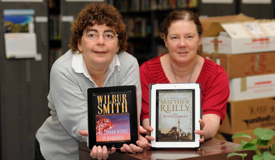 NEW COLLECTION: Wimmera Regional Library collections manager Roslyn Ryan and IT and marketing manager Leanda Elliott with some of the library’s new collection of eBooks, which will be officially launched on Friday. Picture: SAMANTHA CAMARRI