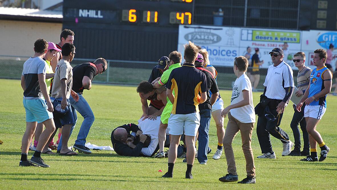 MELEE: Stawell goal umpire Rob Morris and Nhill coach Darren Weavell wrestle on the ground during the incident at half time in the Stawell Warriors and Nhill clash at Central Park. The two were soon separated, but the incident sparked a melee with players from both teams involved. Pictures: MARK McMILLAN