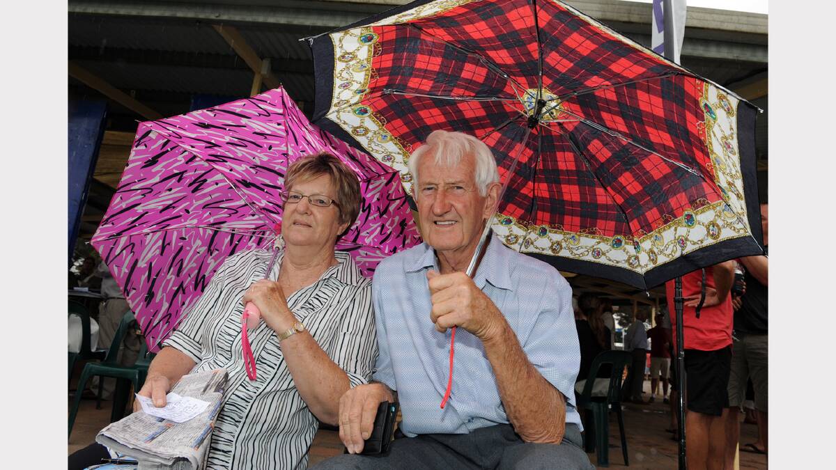 PREPARED: Rainbow's Elaine and Athol Webster shelter from the rain at the Marma Cup at Murtoa on New Year's Day.