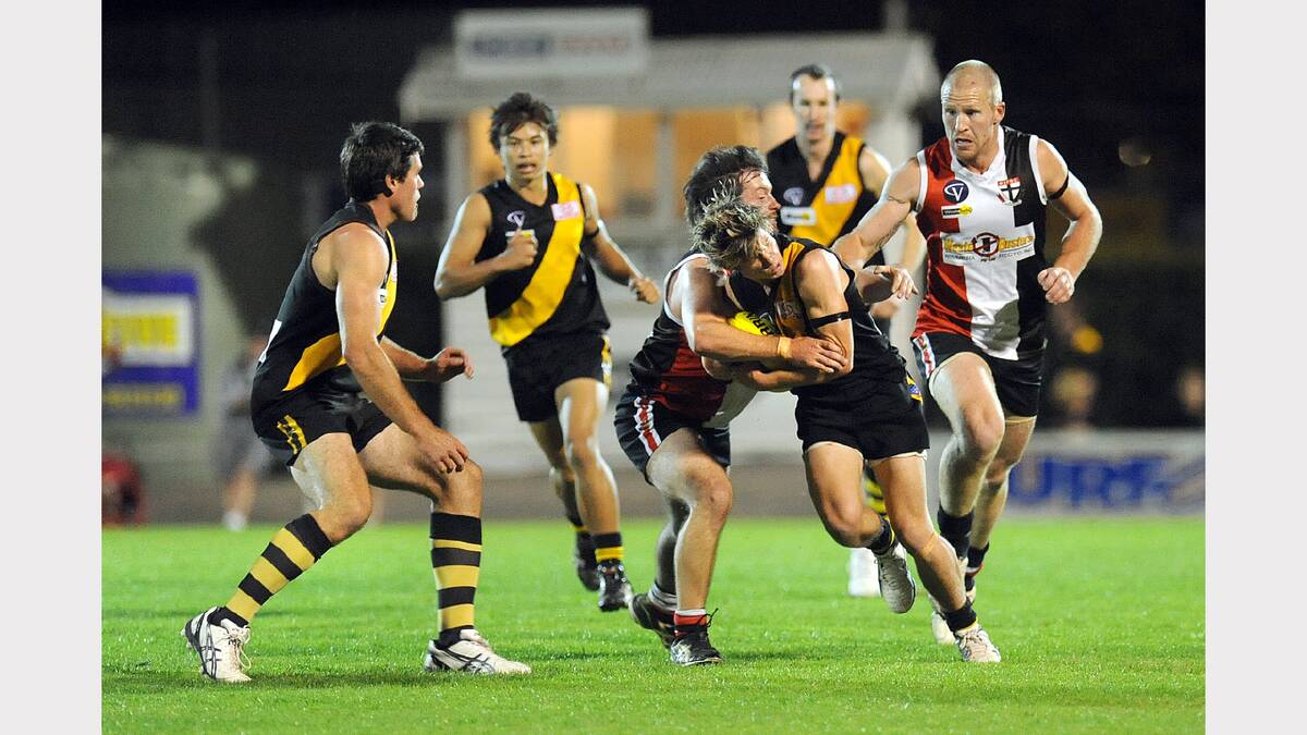 2011: Horsham United's Brodie Mines is tackled by Horsham Saints' Jai Pumphrey during the Anzac Day clash at Horsham City Oval.