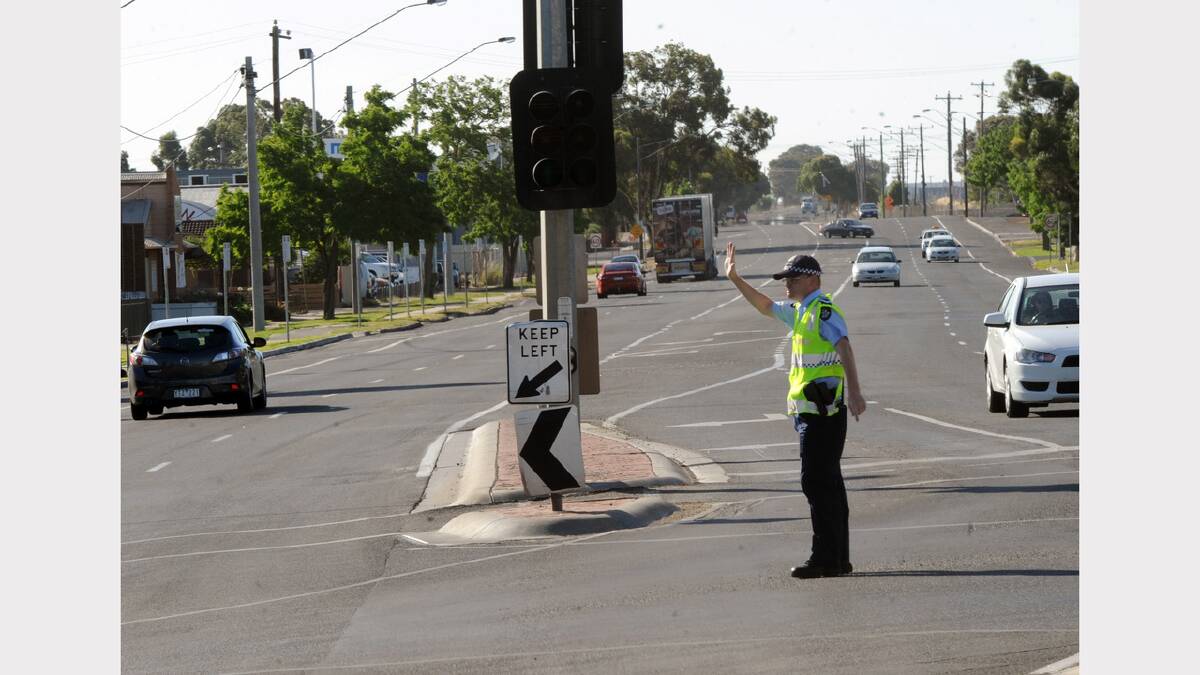 SHOWING THE WAY: Horsham Senior Constable Heath Martin directs traffic in Dimboola Road after power was cut to parts of the city on Saturday afternoon. Picture: PAUL CARRACHER