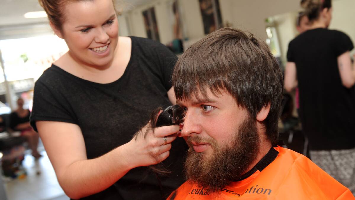 NEW DO: Tegan Kerrins shaves Karl Carman’s head for the World’s Greatest Shave. 