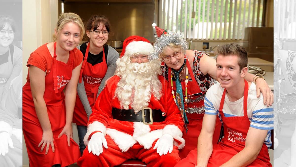 CHRISTMAS SPIRIT: Horsham’s St Brigid’s College volunteers Shauna Stringer, Rowena Baker and Carl Stringer join Santa Claus and Jennifer Teakle as Mrs Tinsel for the final Monday Munchies of the year. Picture: SAMANTHA CAMARRI