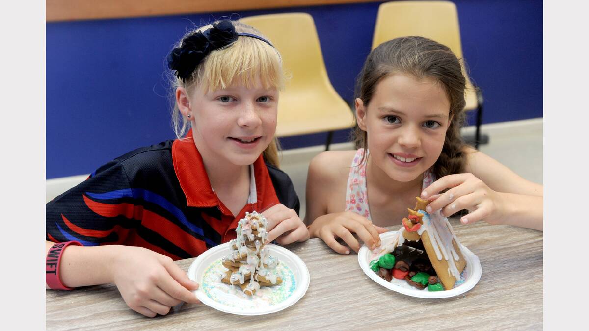 SMILES: Jaclyn Clode, 11, and Ella Brennan, 10, both of Horsham, work on their Christmas treats.