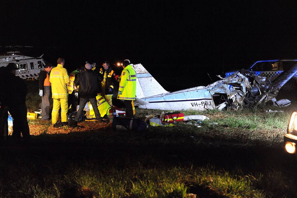 TRAGEDY: Emergency service crews attend to a crash of a light aircraft near Wallup in August 2011. The crash killed two people including Nhill teenager Jacinda Twigg and a pilot from Yarrawonga, Don Kernot. Jacinda's mother later died in hospital as a result of complications from injuries sustained in the accident. The crash has has helped precipitate tighter aviation rules. Picture: PAUL CARRACHER