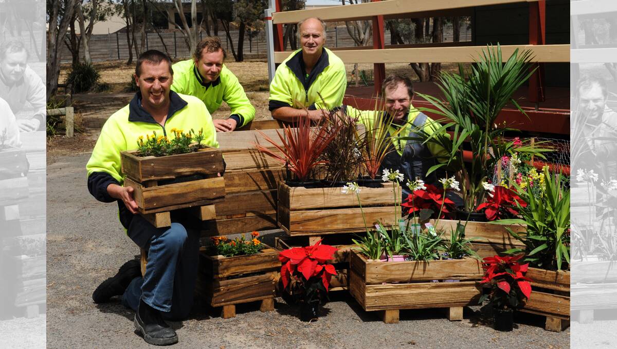 CREATIVE: Jason Perkins, Brendan Russell, Peter McErvale and Wes Howard show plant boxes made from old sheep pens at Horsham’s Axis Works. Picture: PAUL CARRACHER