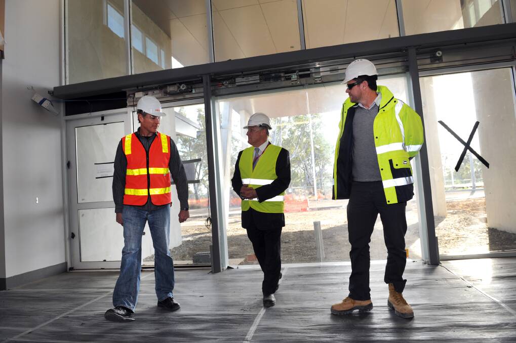 Victorian Corrections Minister Andrew McIntosh, centre, tours the Ararat Prison development in May with construction manager Steve Ritchie, left, and project director Paul Magree. Picture: PAUL CARRACHER